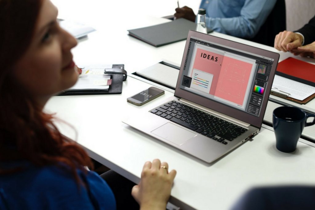 Mulher olhando para notebook em que está escrito "Ideas"